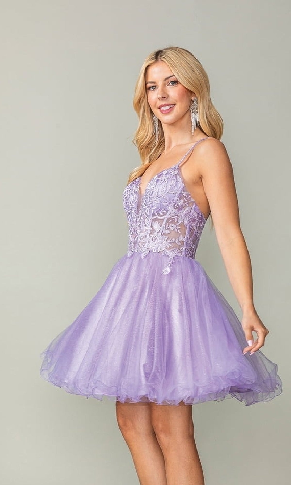 Woman wearing a purple short dress against a plain background